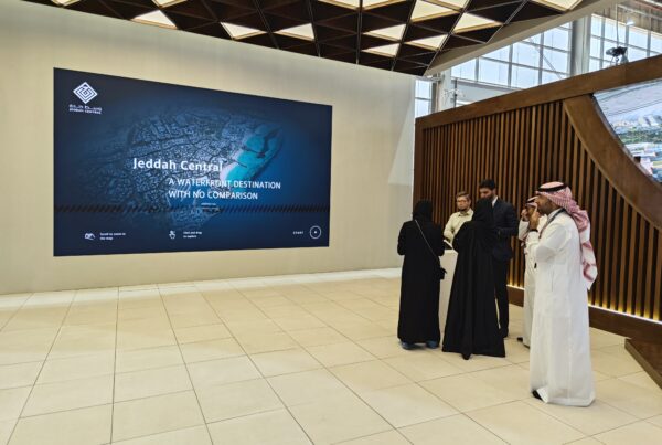 Jeddah Central digital twin presented on a large display in a real estate exhibition environment.