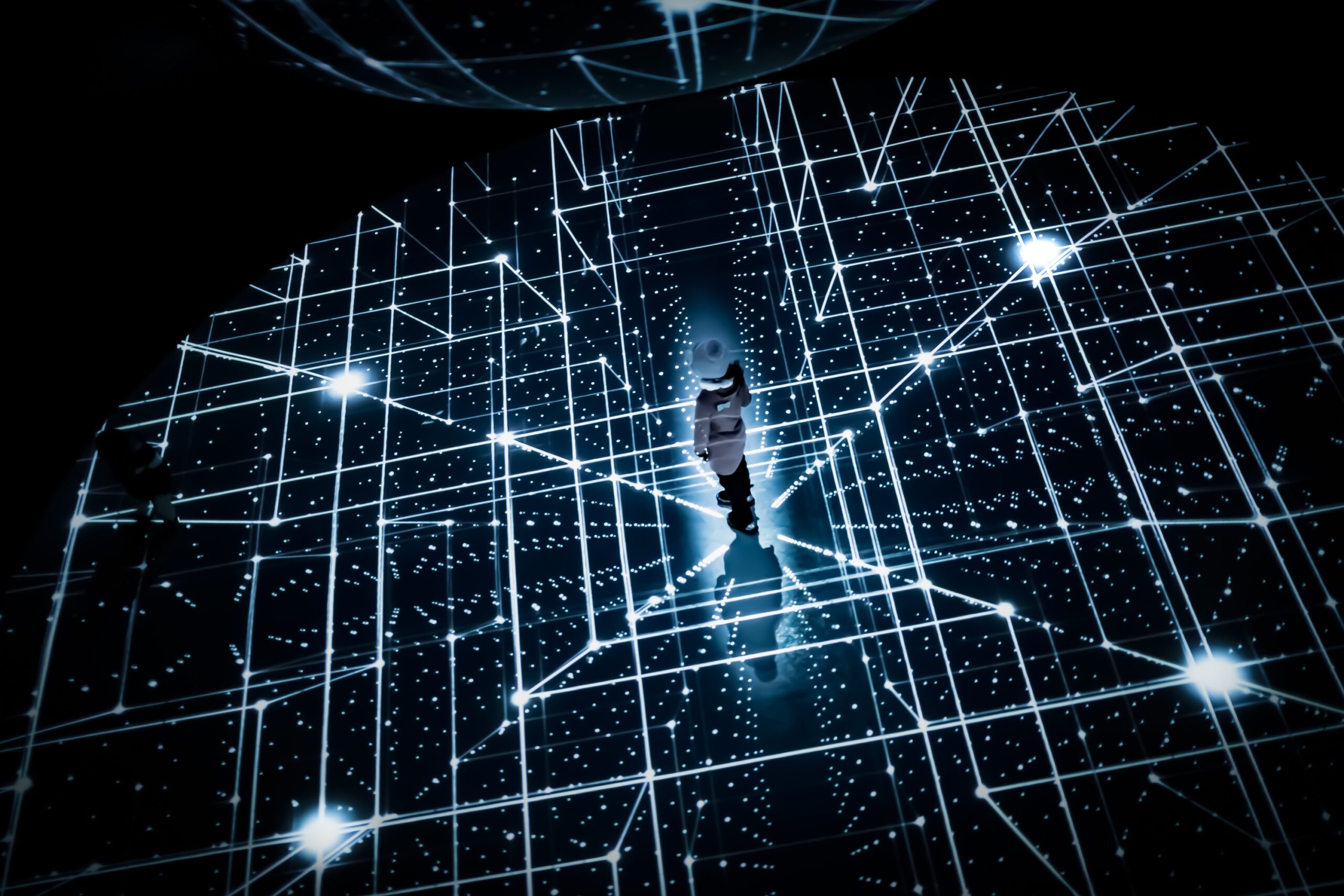 High-angle view of a girl standing within a grid of illuminated digital lines, creating an immersive visual experience.