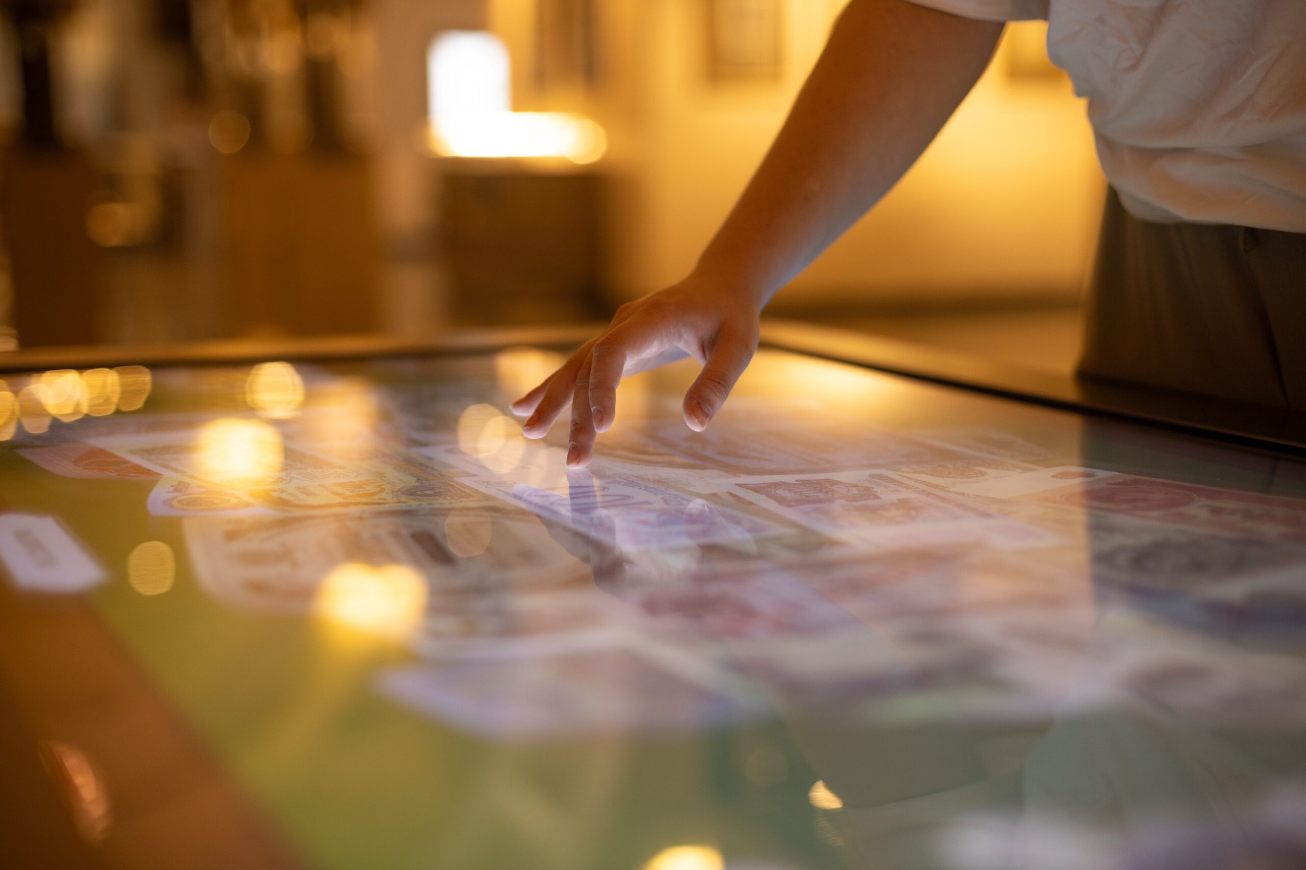 Interactive touch screen displaying dynamic digital content at an event, illustrating the power of immersive event technology for enhanced customer engagement.