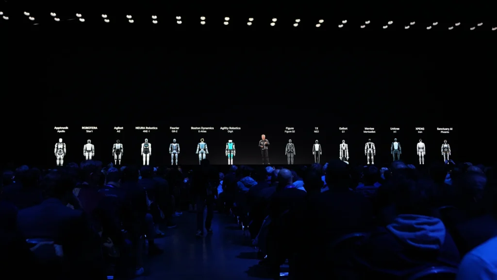 A futuristic conference showcasing humanoid robots on stage, with a large audience observing the presentation. The image highlights the synergy between cutting-edge GPU technology, such as the GeForce GTX 5000, and its applications in interactive technology for events. It also emphasizes the role of advanced visualization in creating immersive digital twin solutions for real estate and large-scale innovations.