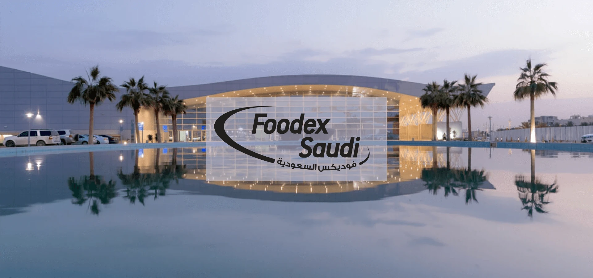 Exterior of Riyadh International Convention & Exhibition Center at dusk with Foodex Saudi logo, palm trees, and a mirror-like reflection pool.
