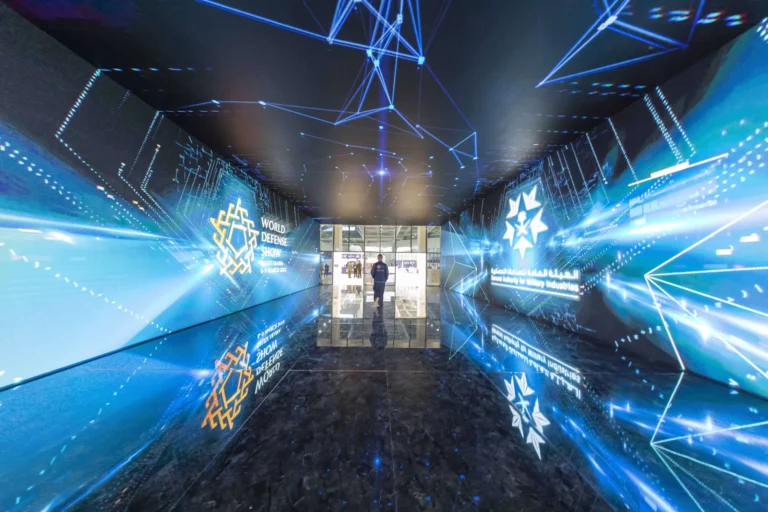Illustration of an immersive booth with surrounding digital displays.
