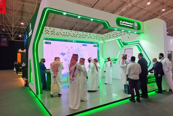Attendees engaging with the Riyadh Digital Twin at the Riyadh Region Municipality stand during Future Projects Forum, interactive LED display and booth signage visible.