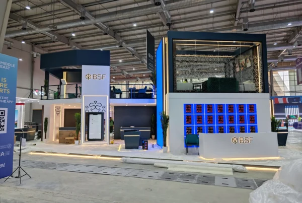 Front view of the two-level BSF stand under installation, mobile app screen frame and LED tests visible at Money20/20 Riyadh.