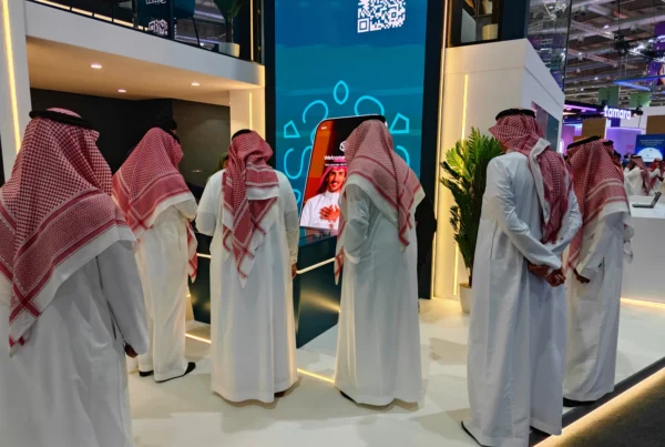 Visitors engaging with BSF’s giant vertical Mobile App Explorer interactive banking demo at Money20/20 Riyadh.