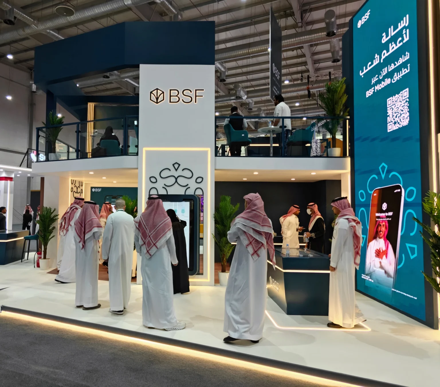 BSF booth at Money20/20 Riyadh with a tangible table and large mobile app display.