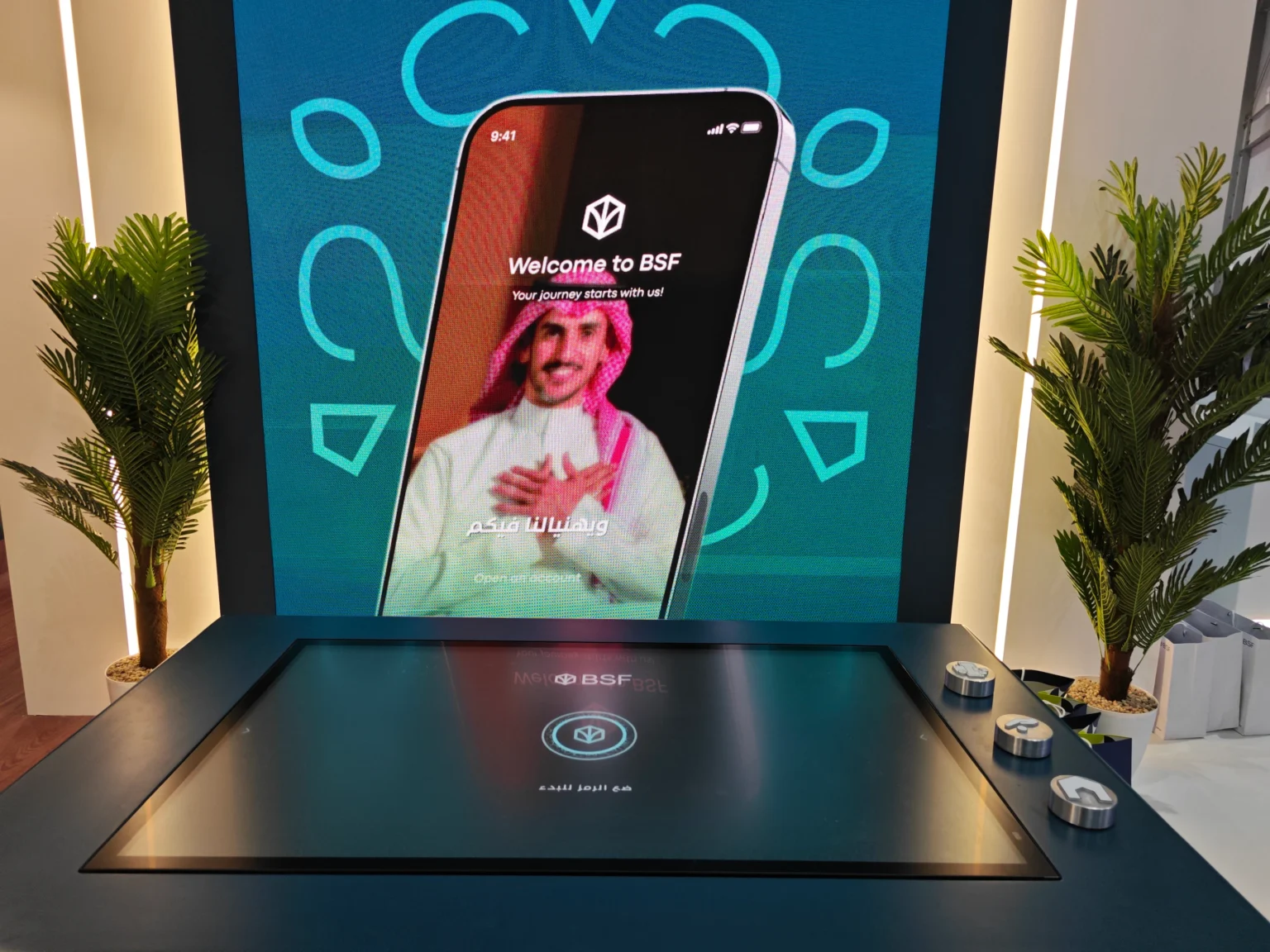 BSF tangible table with physical tokens and a large banking product display at Money20/20 Riyadh.